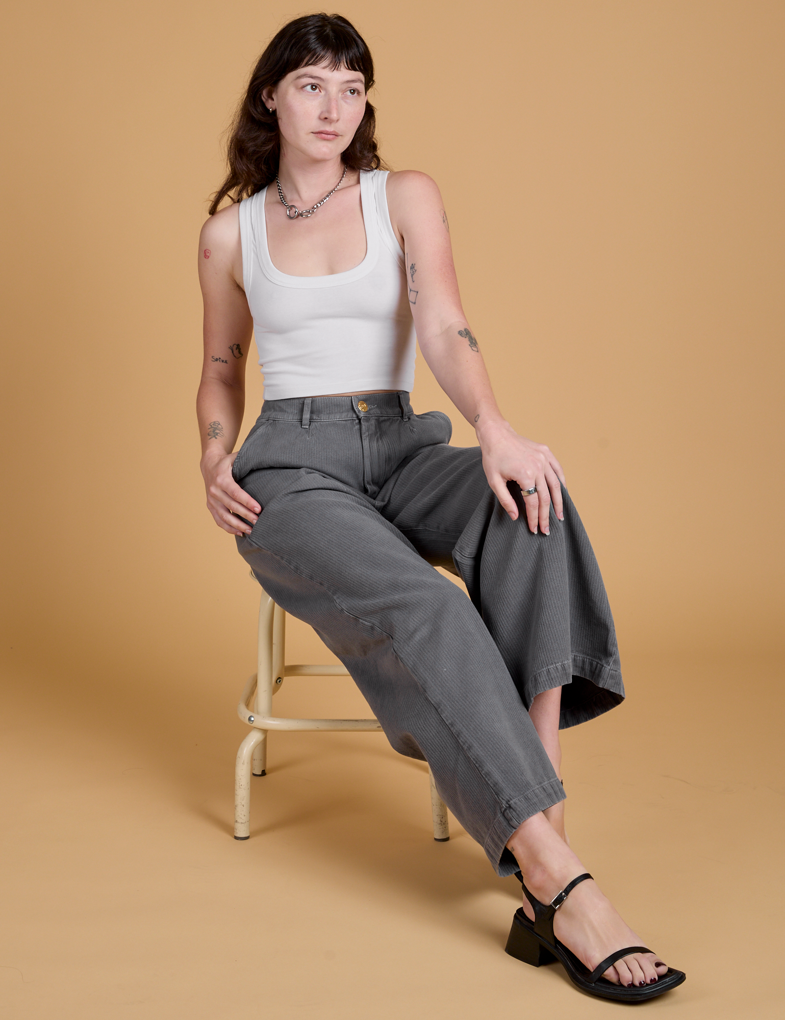 Alex is wearing Heritage Wide Leg Trousers in Washed Grey and Cropped Tank in Vintage Tee White