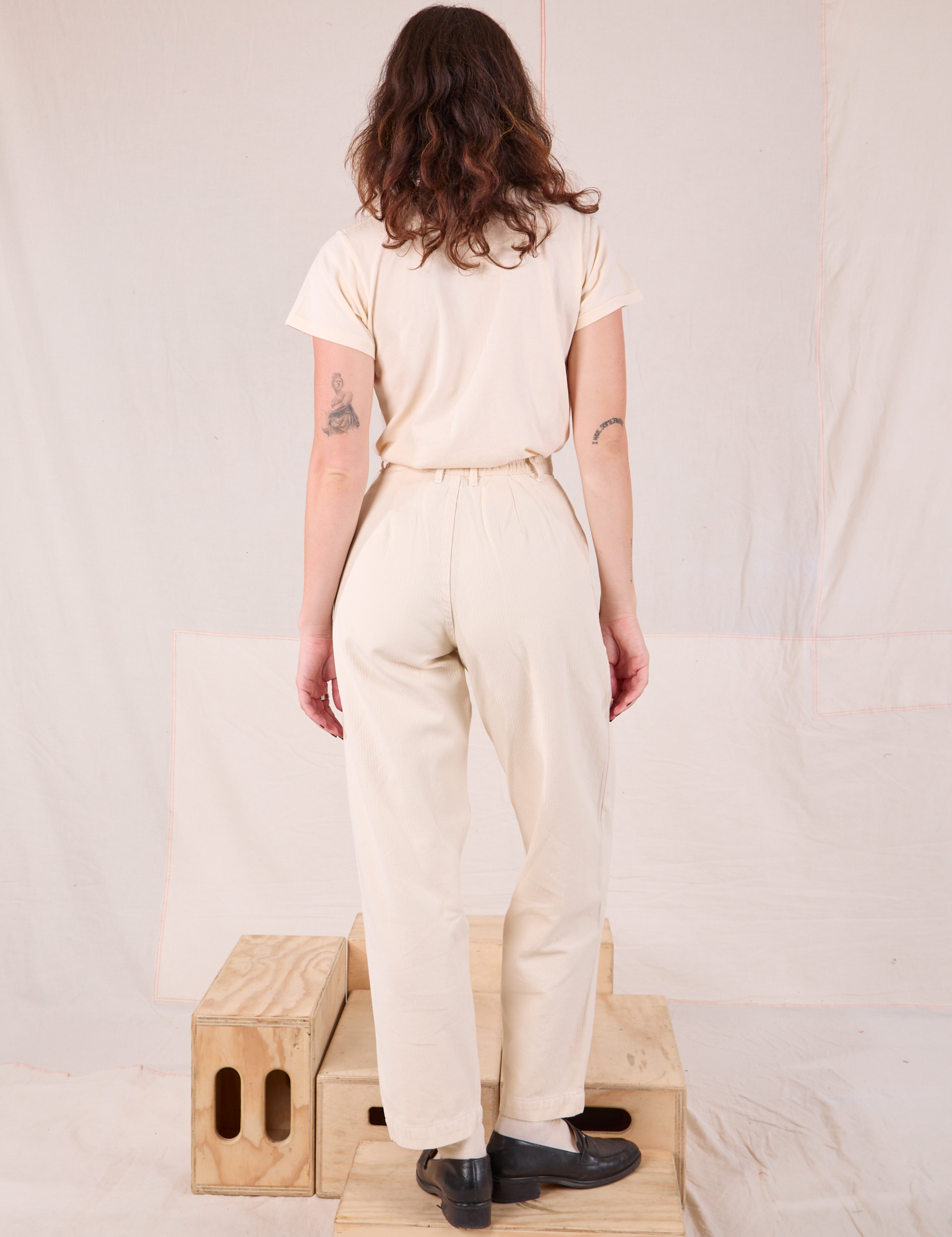 Back view of Heritage Trousers in Natural  and Organic Vintage Tee in vintage tee off-white on Alex