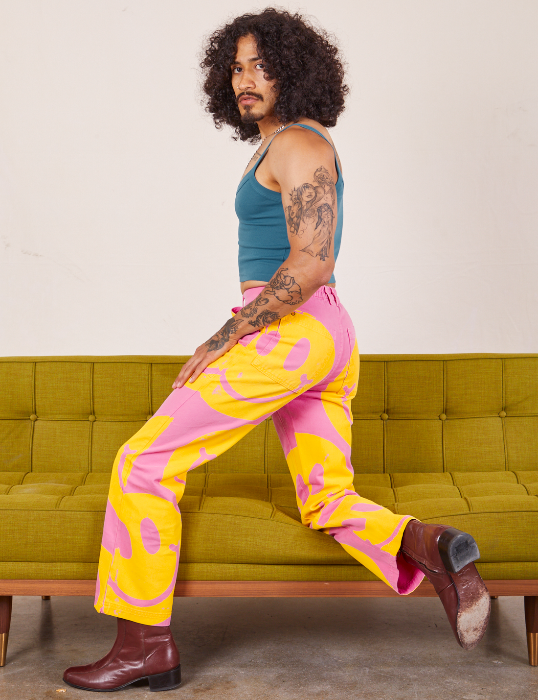Side view of Icon Work Pants in Smilies and marine blue Cropped Cami worn by Jesse.