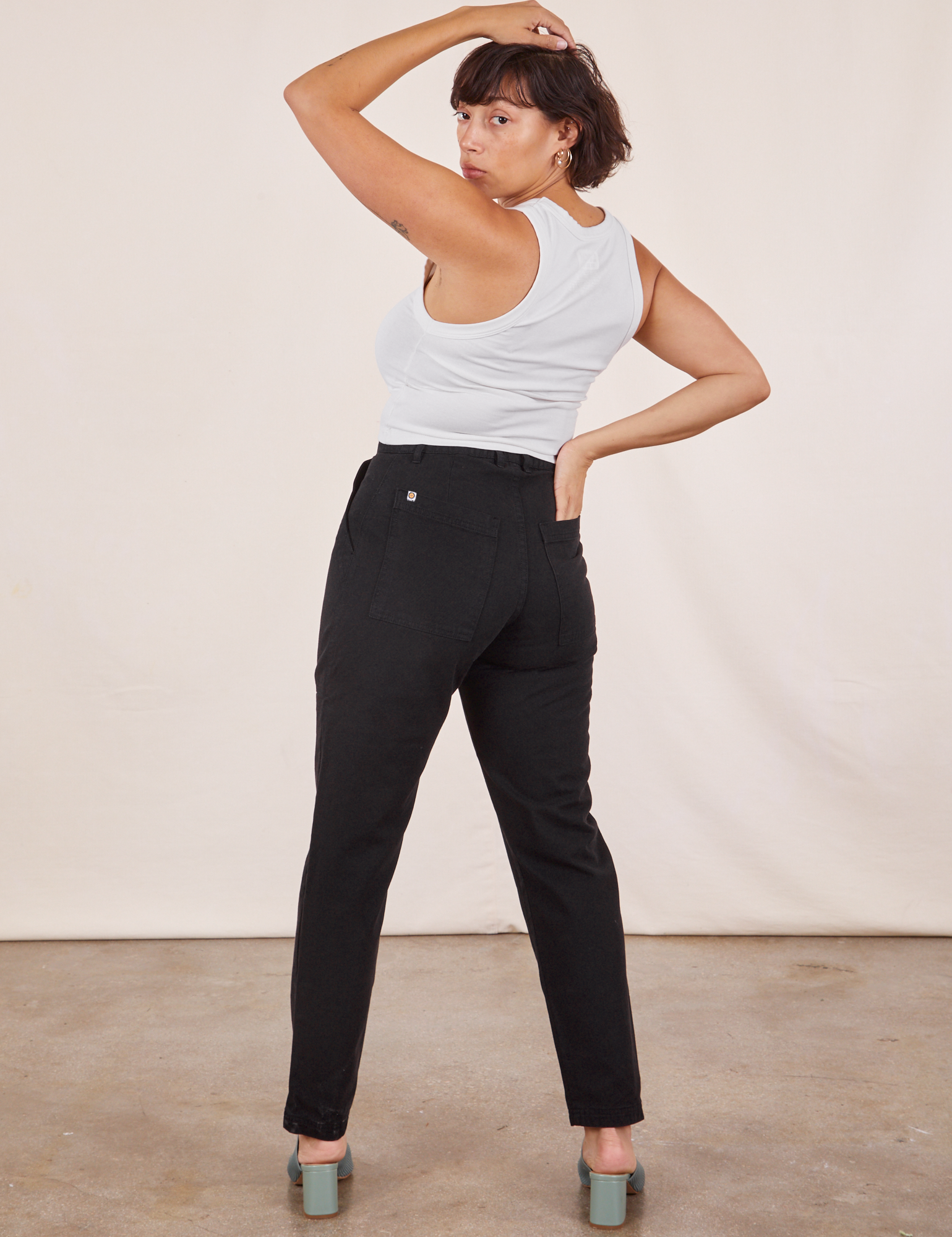 Back view of Pencil Pants in Basic Black and vintage off-white Tank Top worn by Tiara