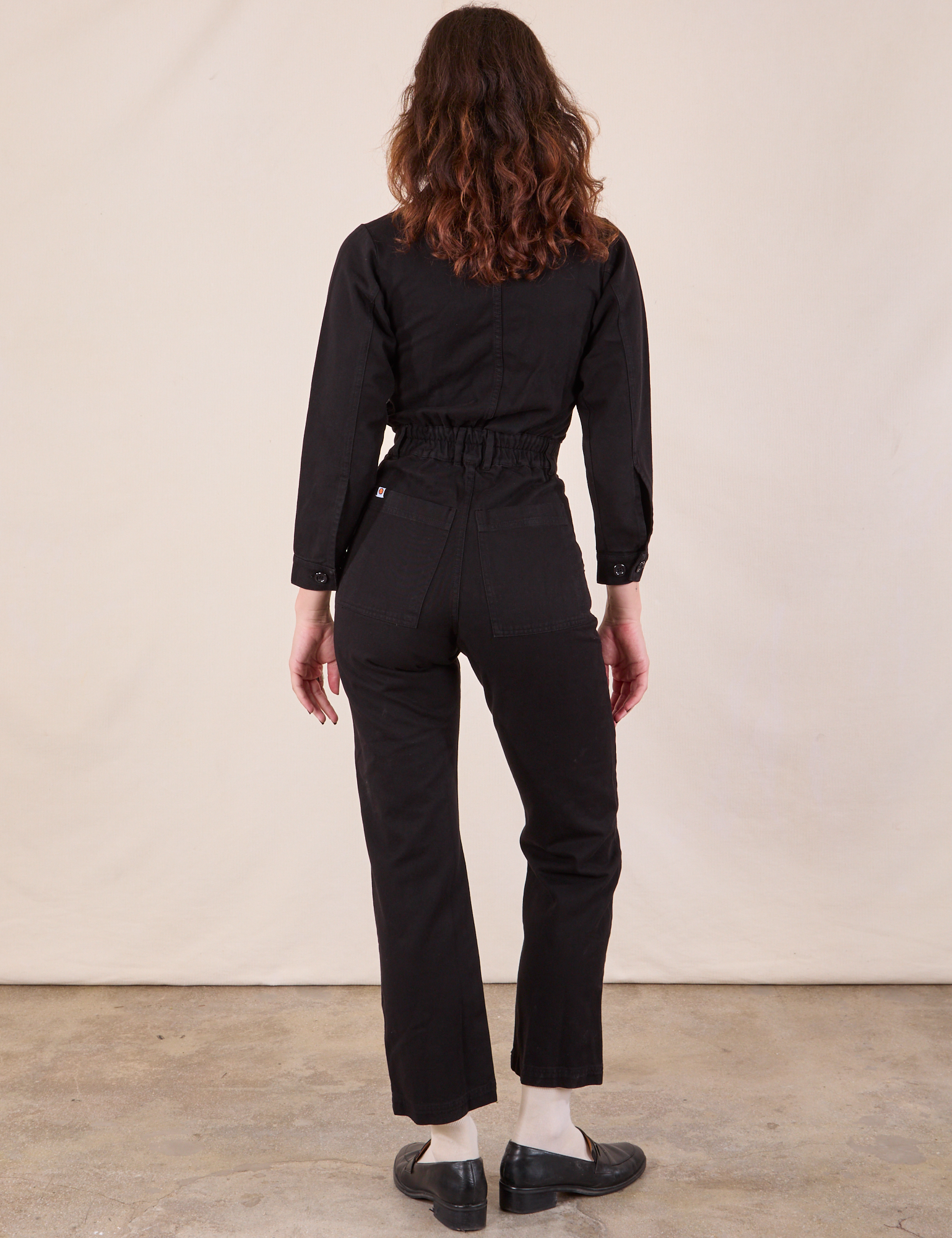 Long Sleeve Jumpsuit in Basic Black back view on Alex