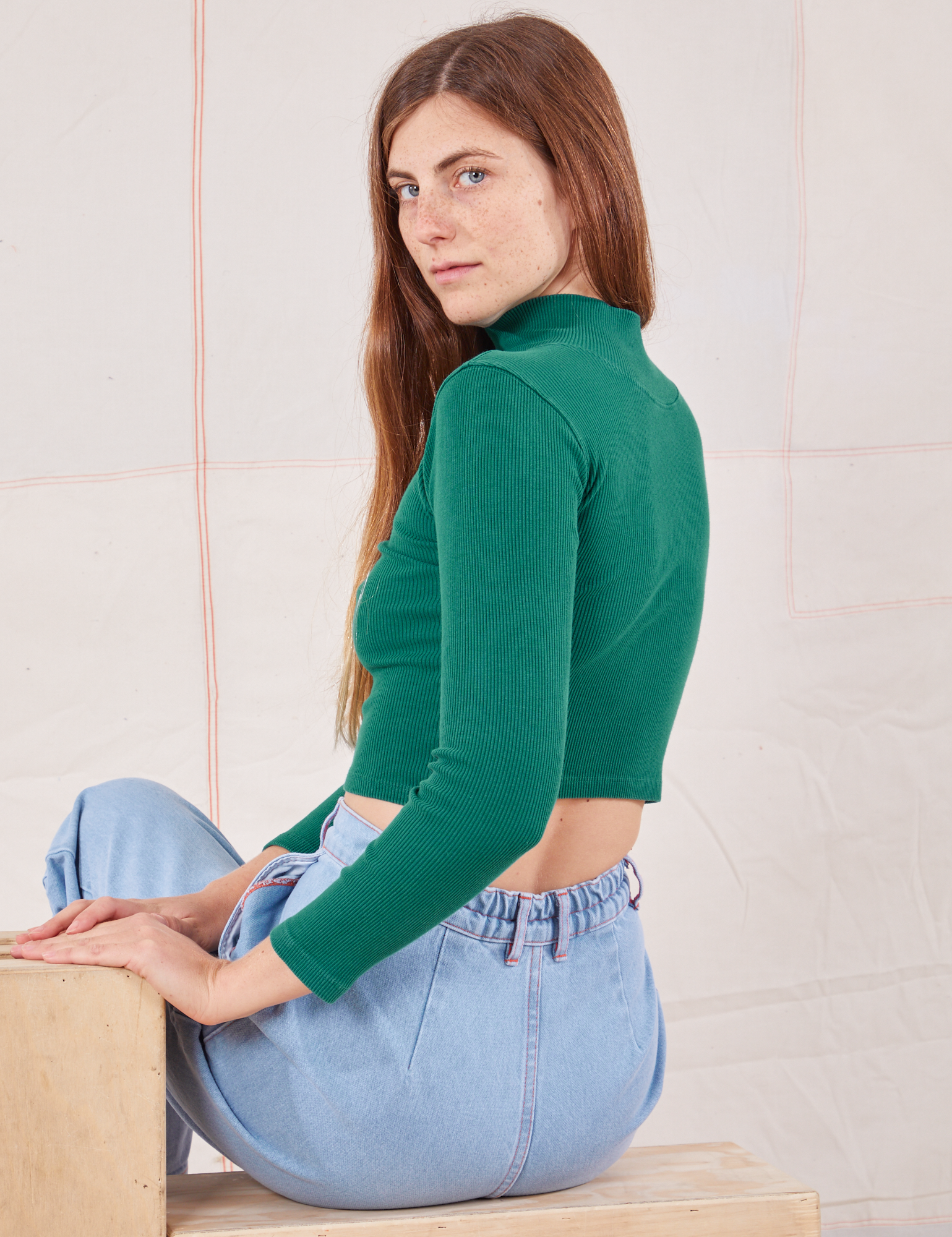 Essential Turtleneck in Hunter Green angled back view on Scarlett
