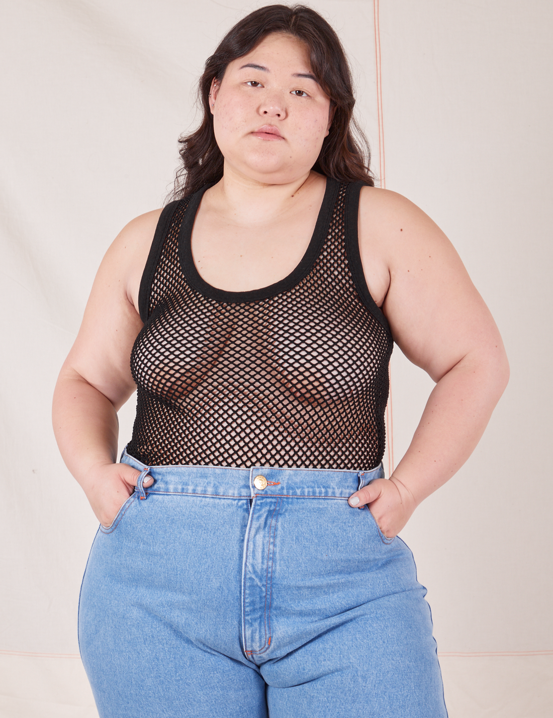 Ashley is 5'7" and wearing L Mesh Tank Top in Basic Black