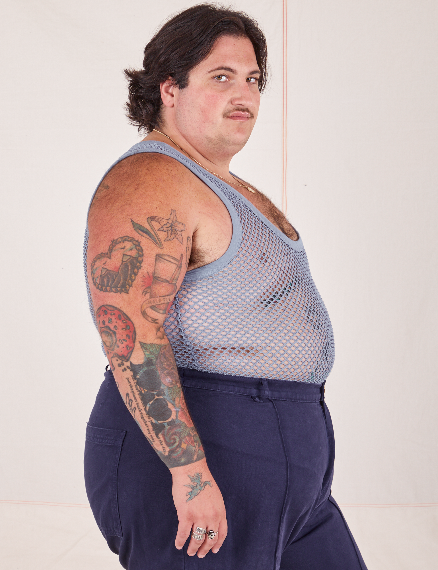 Side view of Mesh Tank Top in Periwinkle and navy Western Pants worn by Sam