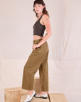 Side view of Mid-Rise Pleated Trousers in Desert Brown and espresso brown Cropped Tank on Alex