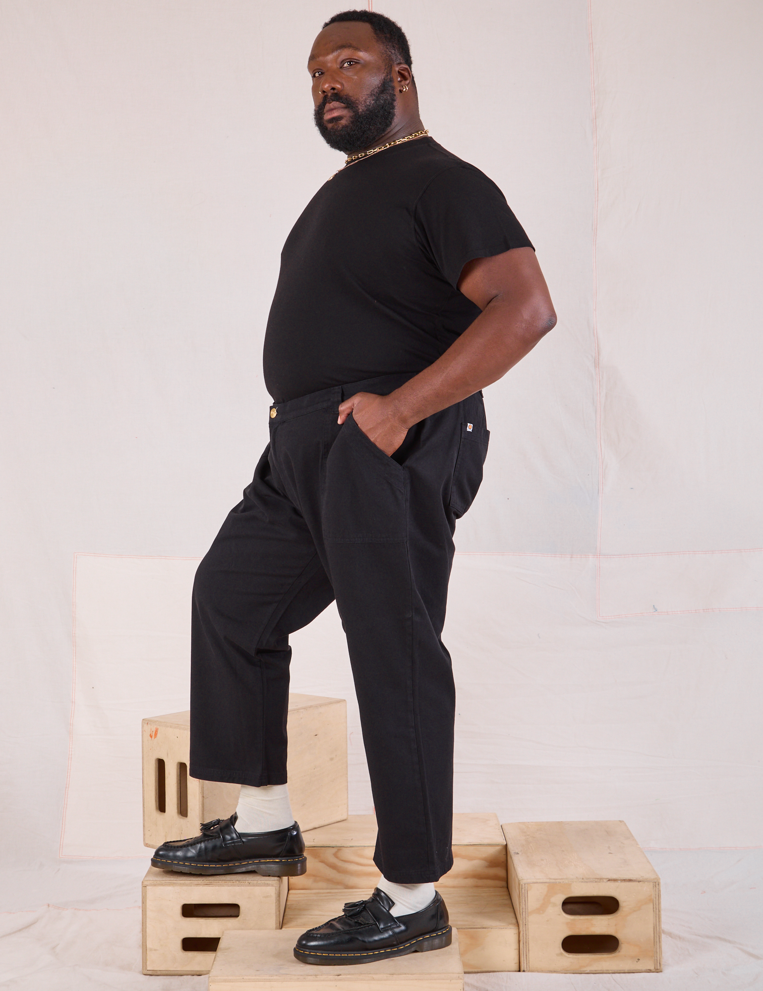 Side view of Mid-Rise Work Pants in Basic Black and black Organic Vintage Tee on Elijah