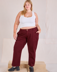 Juliet is 5'7" and wearing 2XL Mid-Rise Work Pants in Red Wine paired with a Cropped Tank in vintage tee off-white