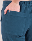 Mid-Rise Work Pants in Lagoon close up of Margaret's hand in the back pocket