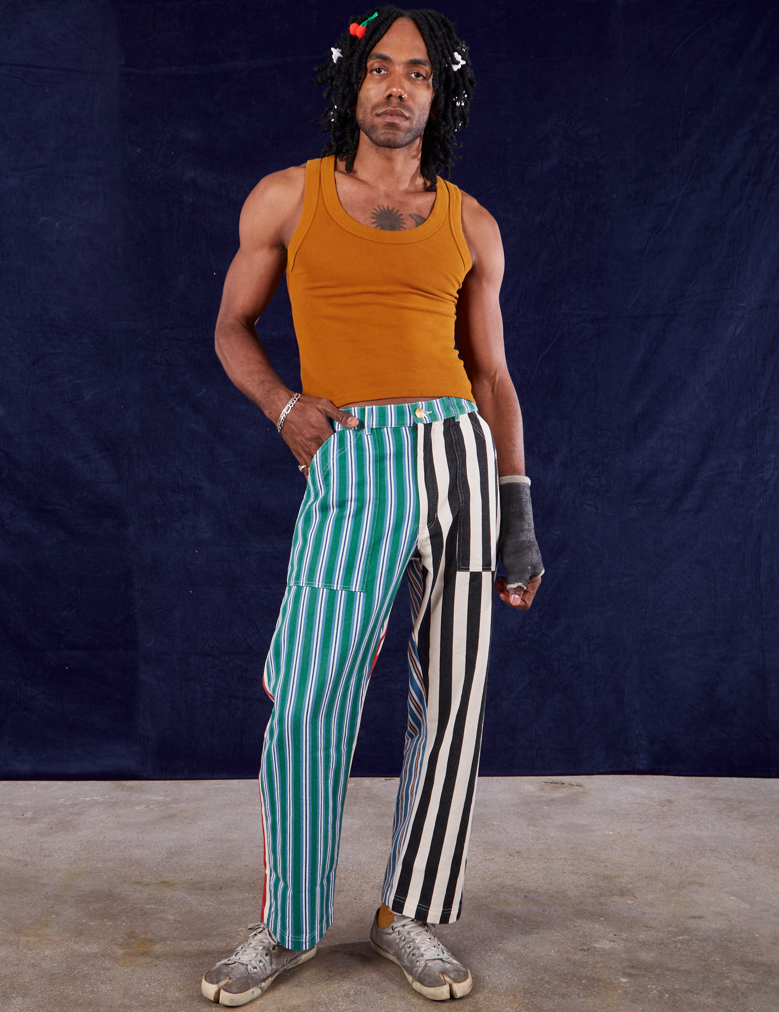 Jerrod is 6&#39;3&quot; and wearing S 4-Way Stripe Work Pants paired with spicy mustard Tank Top