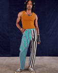 Jerrod is 6'3" and wearing S 4-Way Stripe Work Pants paired with spicy mustard Tank Top