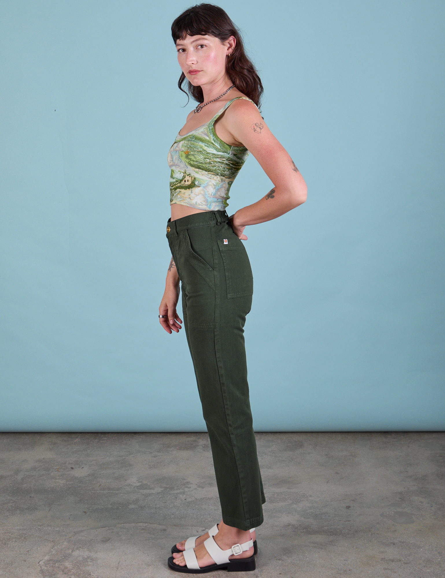 Side view of Ocean and Sky in Cami and swamp Work Pants on Alex
