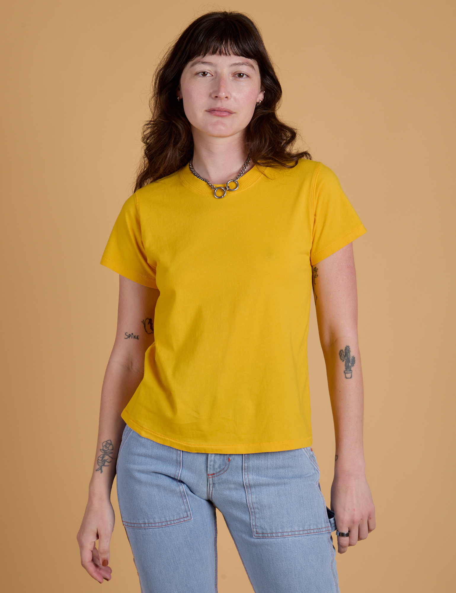 Alex is 5’8” and wearing P Organic Vintage Tee in Sunshine Yellow