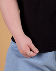 Bottom close up of Organic Vintage Tee in Basic Black with Ashley holding the hem
