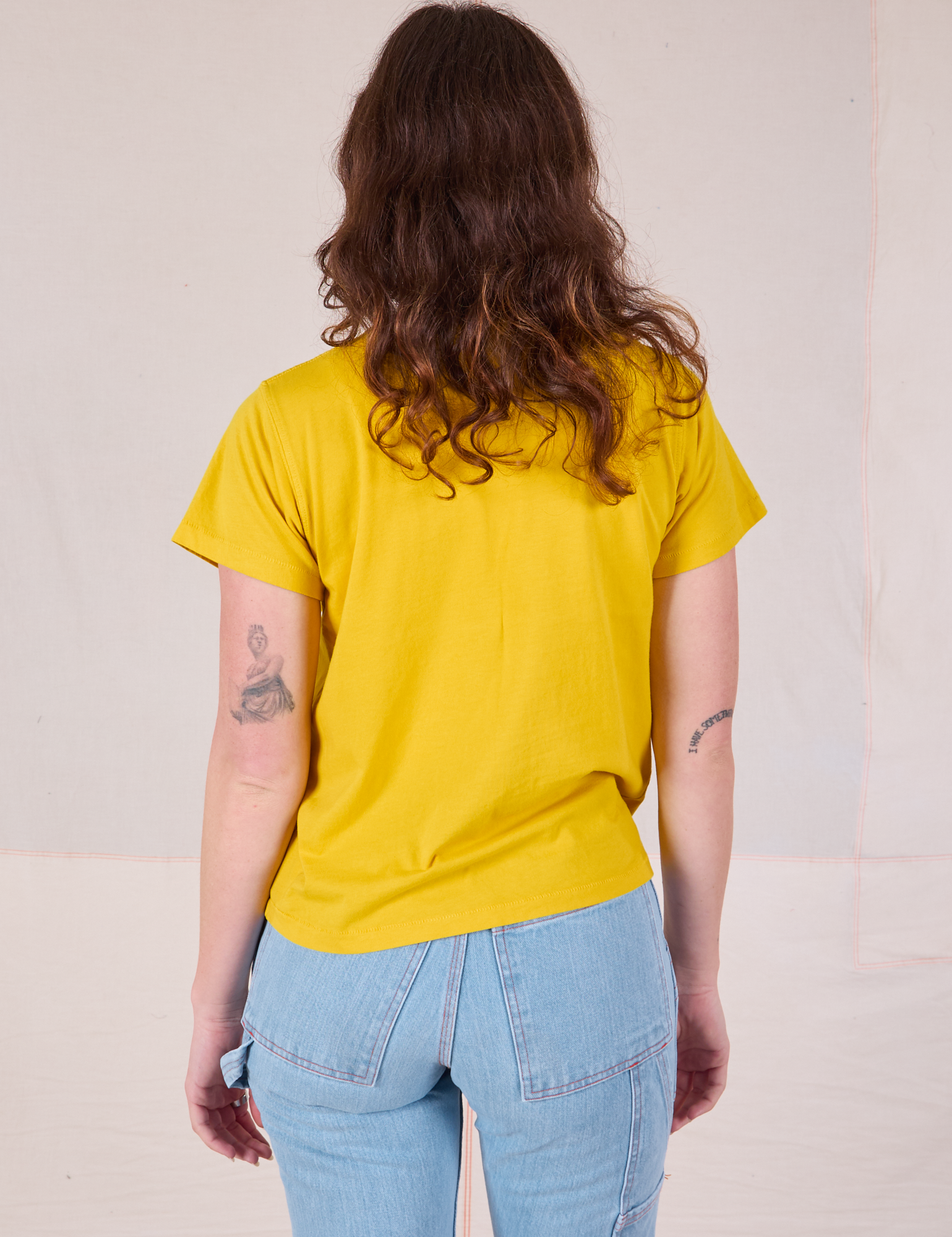 Organic Vintage Tee in Golden Yellow back view on Alex