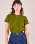 Alex is wearing Organic Vintage Tee in Summer Olive tucked into dark wash Carpenter Jeans