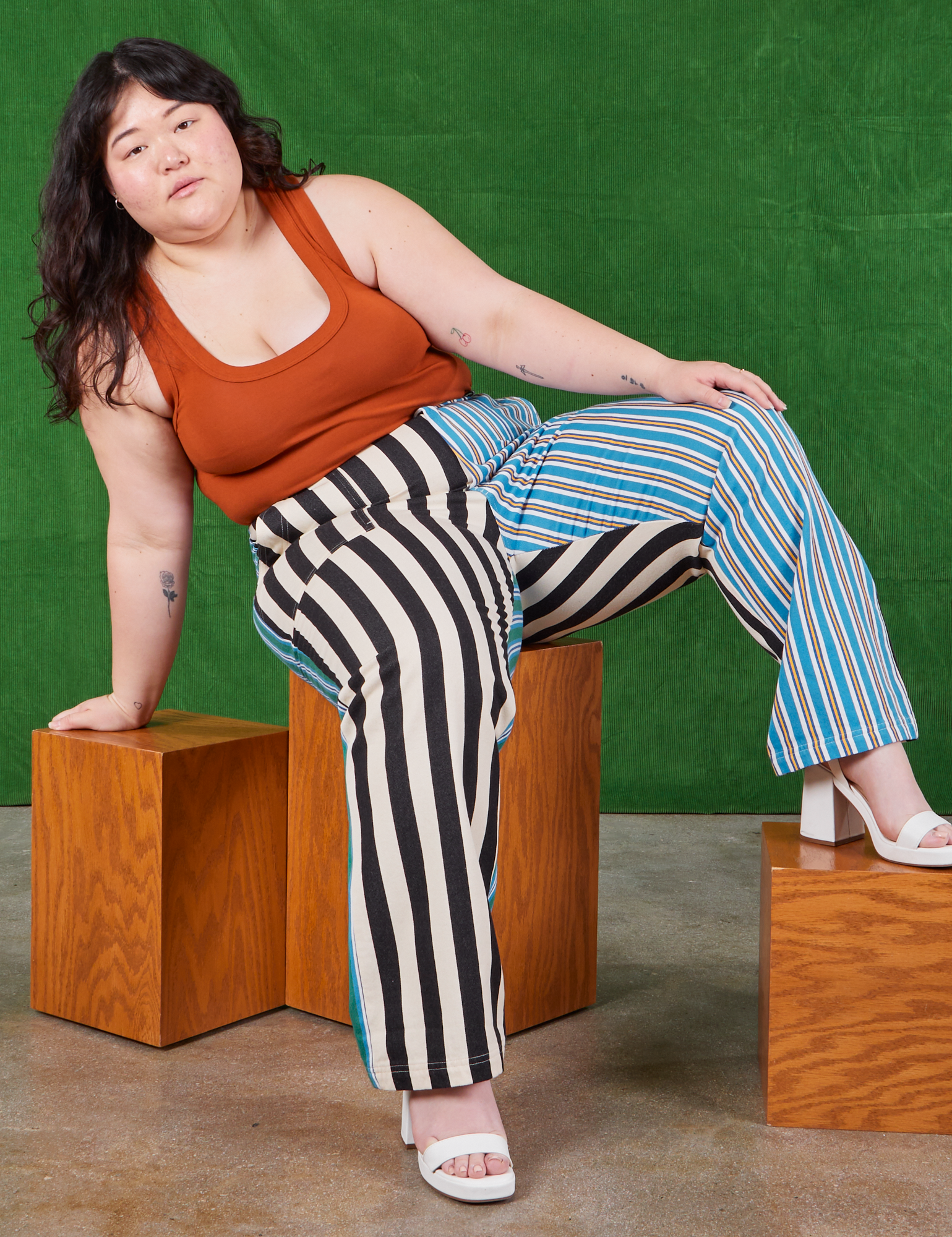 Ashley is wearing Mismatched Stripe Work Pants and burnt terracotta Cropped Tank Top