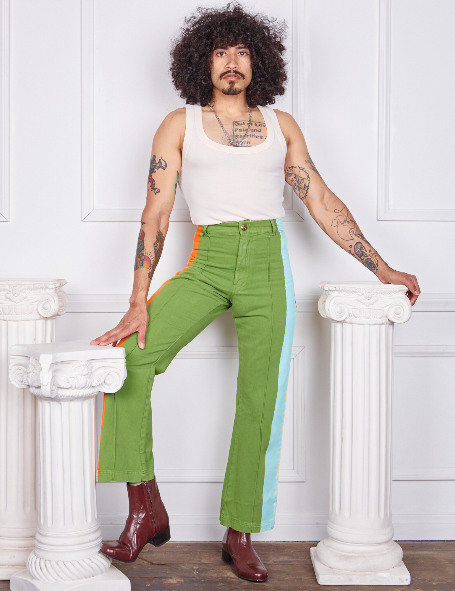 Jesse is 5&#39;8&quot; and wearing XS Hand-Painted Stripe Western Pants in Bright Olive paired with a vintage off-white Tank Top