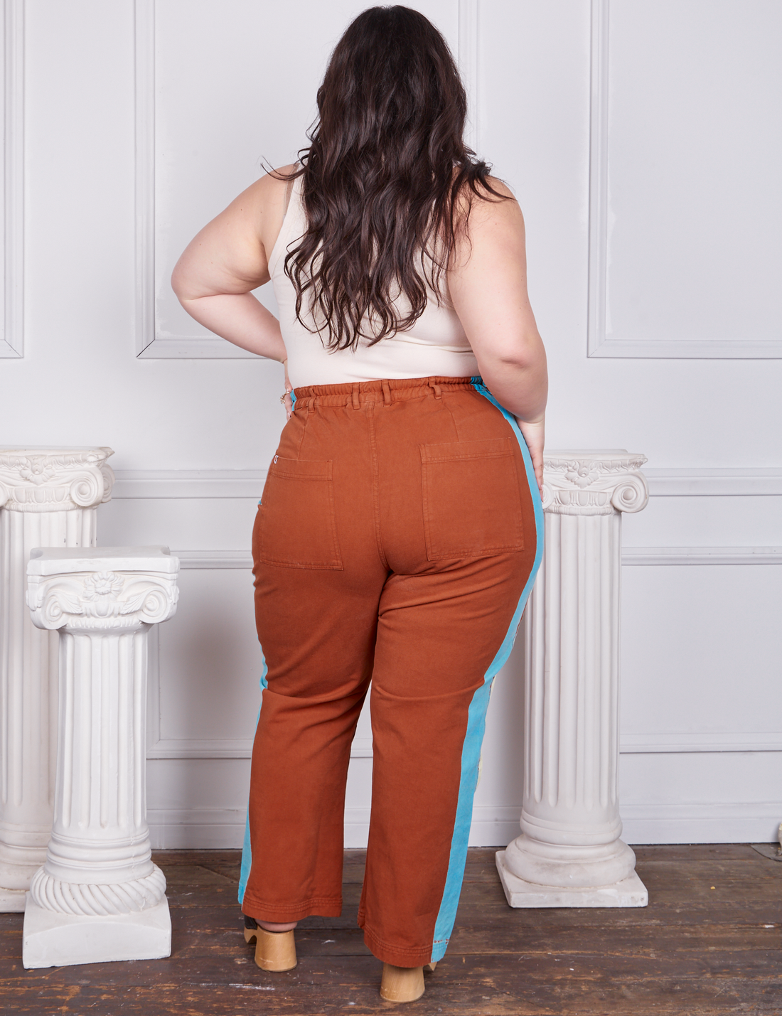 Back view of Hand-Painted Stripe Western Pants in Burnt Terracotta worn by Ashley