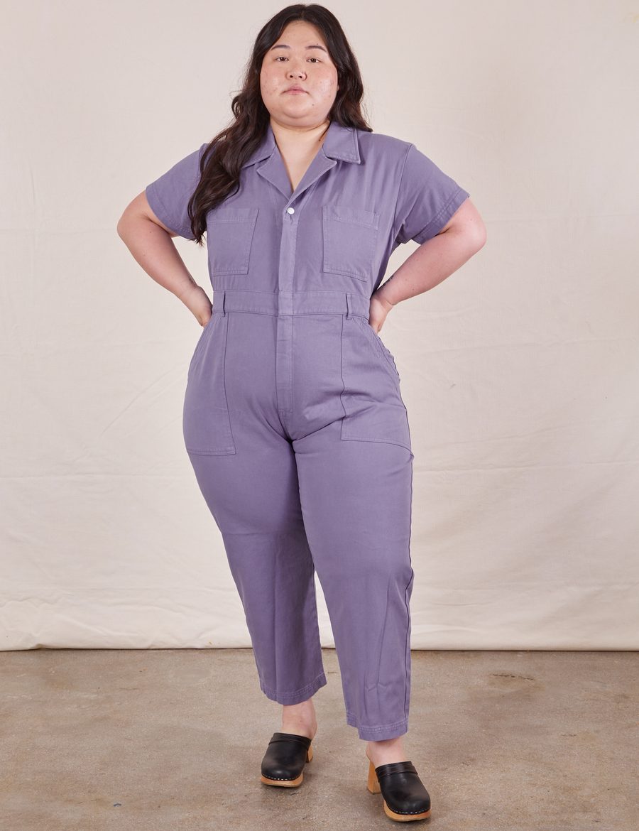 Ashley is 5’7” and wearing 1XL Petite Short Sleeve Jumpsuit in Faded Grape