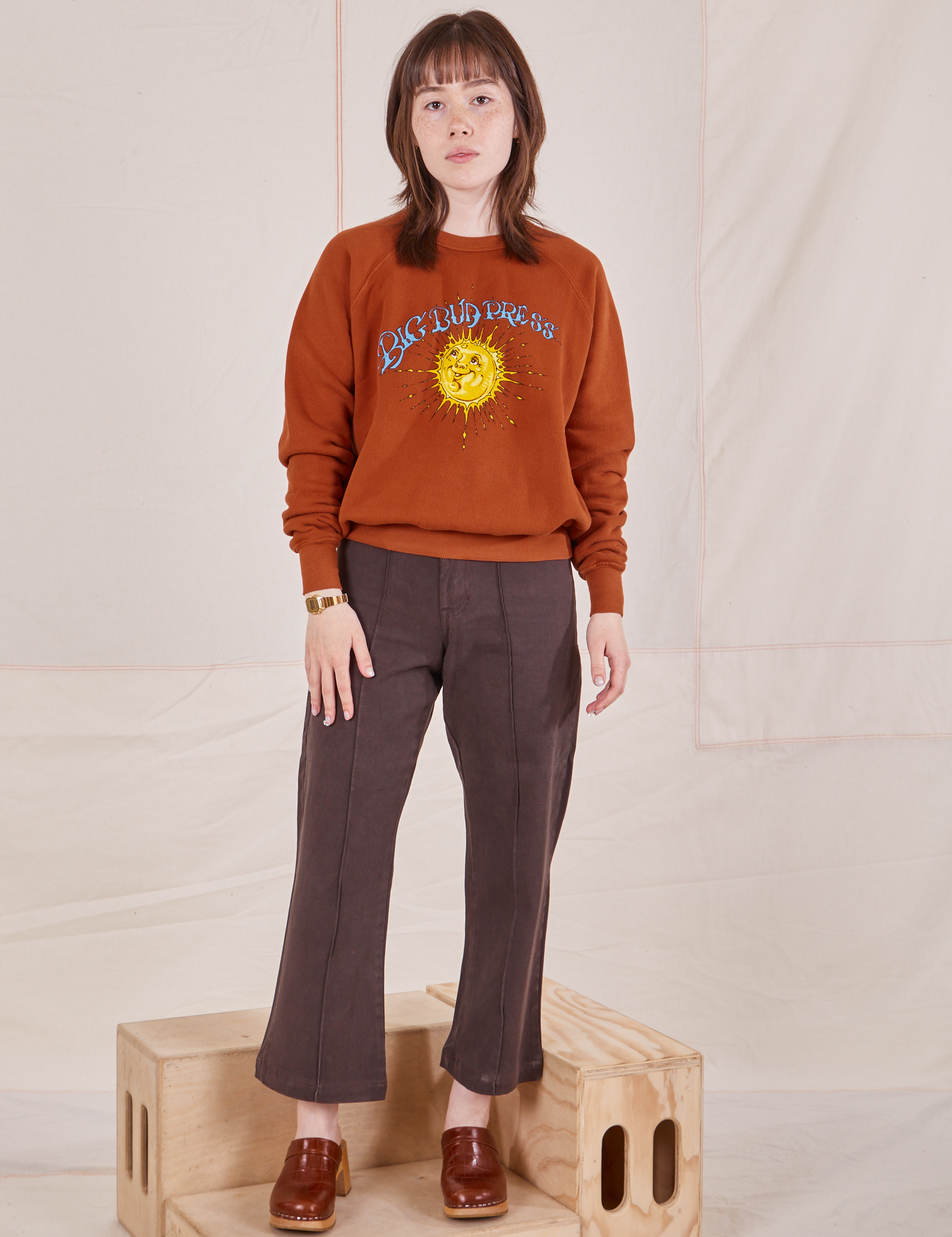 Hana is 5&#39;3&quot; and wearing P Bill Ogden&#39;s Sun Baby Crew paired with an espresso brown Western Pants