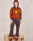 Hana is 5'3" and wearing P Bill Ogden's Sun Baby Crew paired with an espresso brown Western Pants