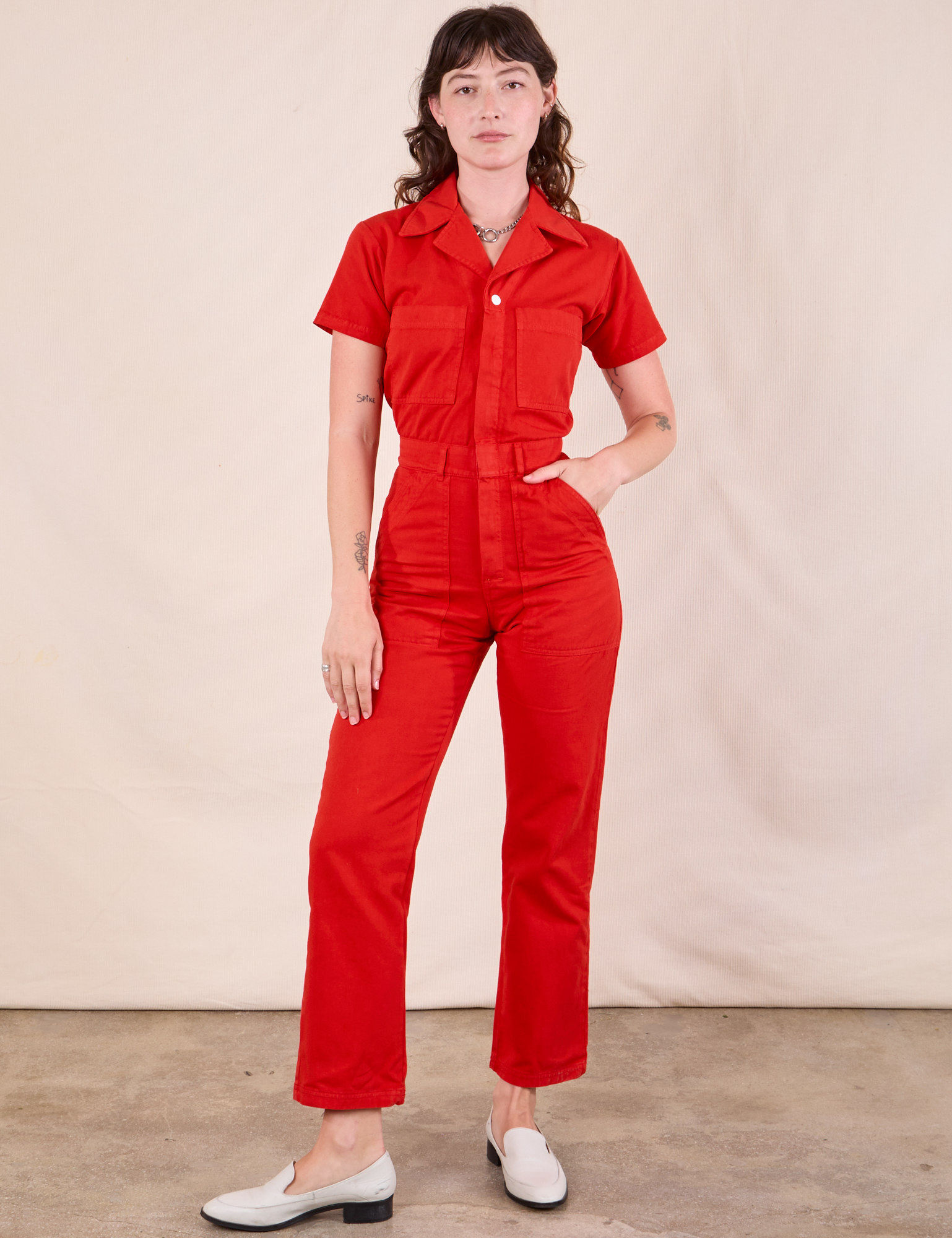 Alex is 5&#39;8&quot; and wearing XXS Short Sleeve Jumpsuit in Mustang Red