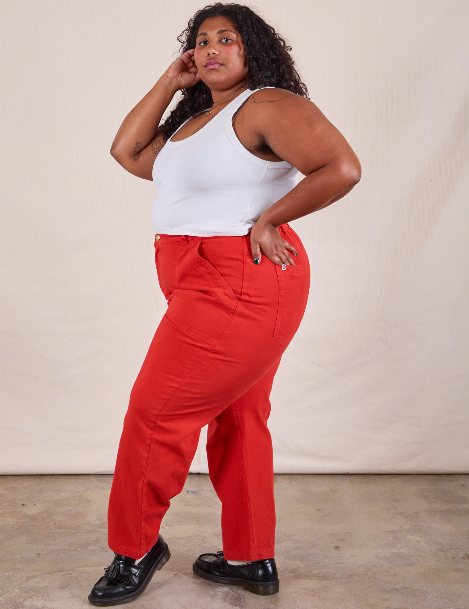 Side view of Work Pants in Mustang Red and Cropped Tank in VIntage Tee Off-White