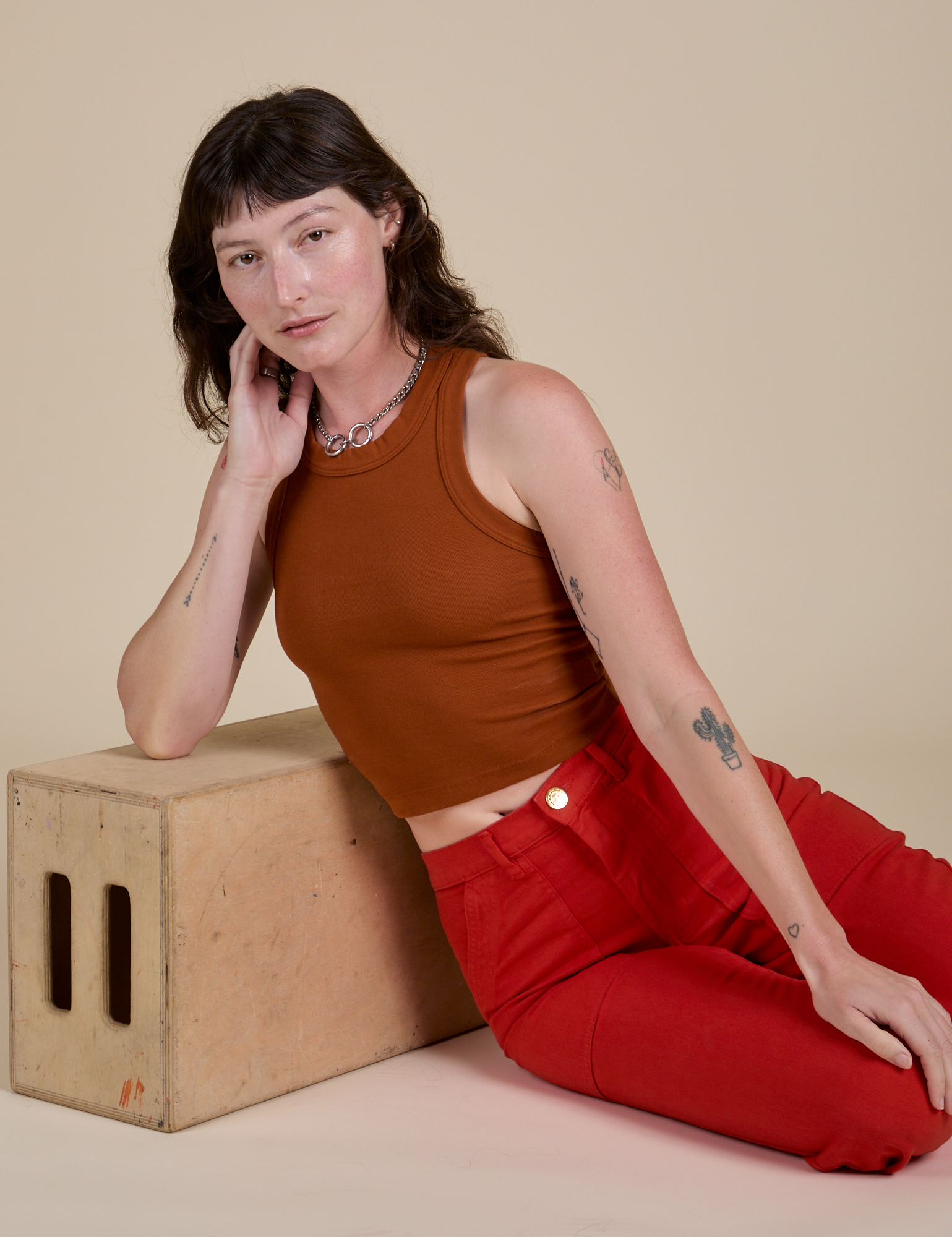 Alex is wearing Racerback Tank in Burnt Terracotta and mustang red Work Pants