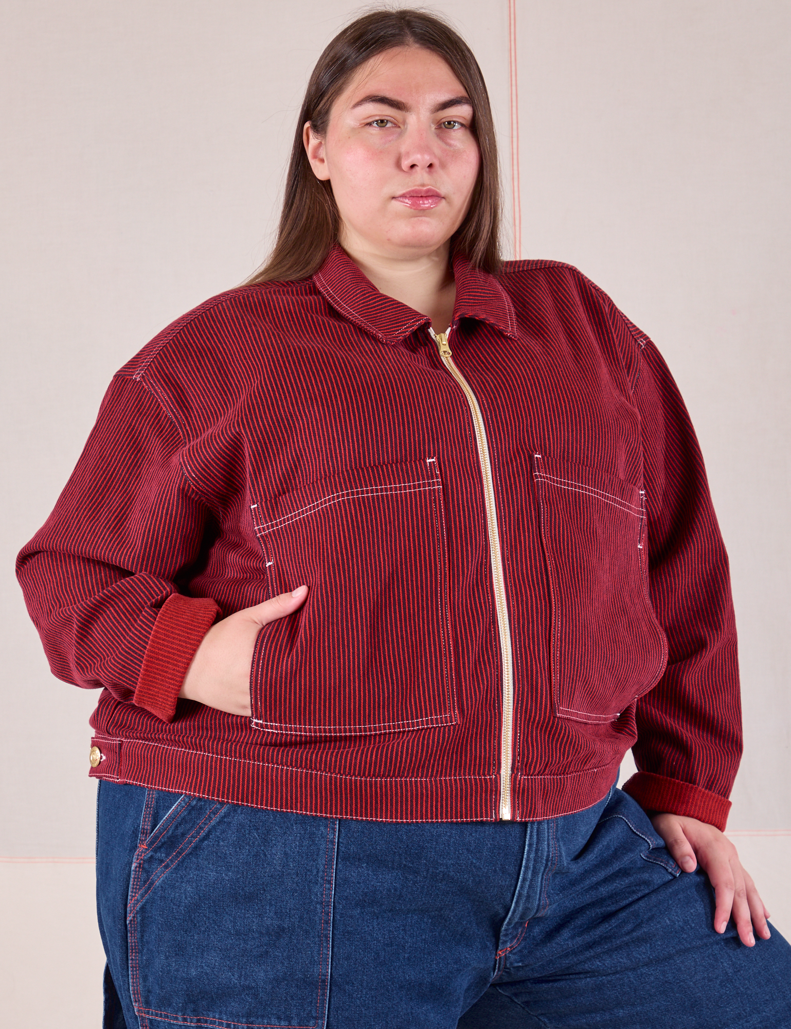 Marielena is wearing a zipped up Mechanic Jacket in Mustang Red