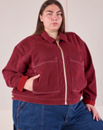 Marielena is wearing a zipped up Mechanic Jacket in Mustang Red