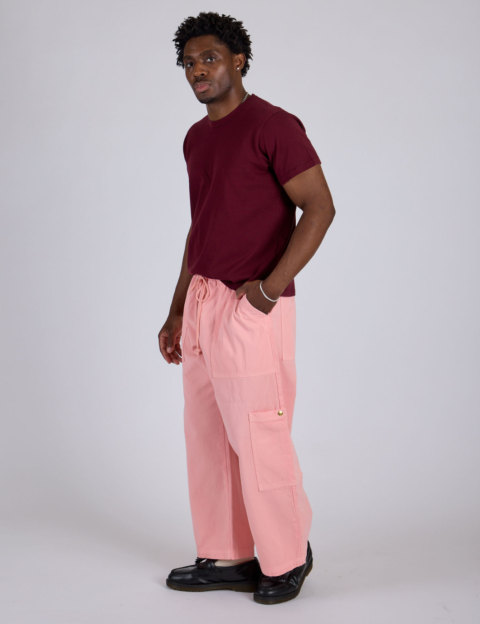Side view of Drop Pocket Cargo Pants in Baby Pink and red wine Organic Vintge Tee on Isaac