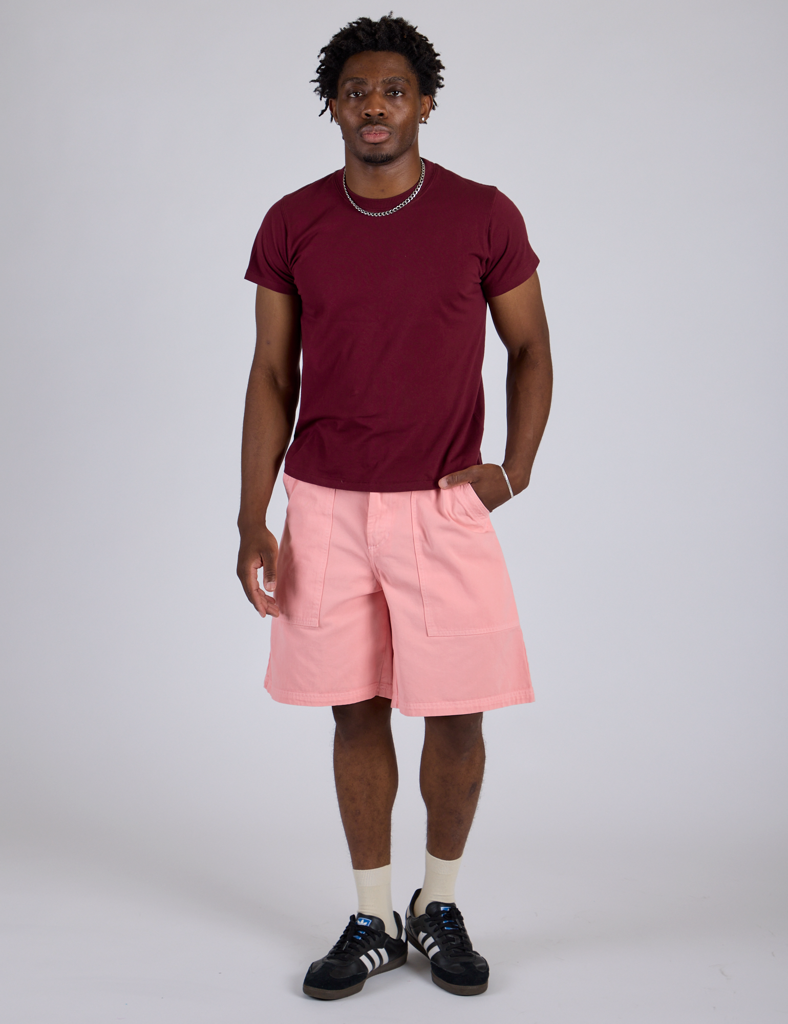 Isaac is 5’10” and wearing M Longline Work Shorts in Baby Pink paired with red with Organic Vintage Tee