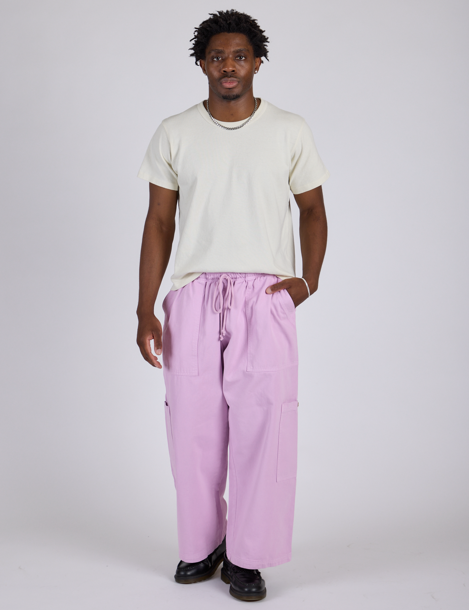 Isaac is 5’10” and wearing M Drop Pocket Cargo Pants in Lilac Purple paired with Organic Vintage Tee in Vintage Tee White