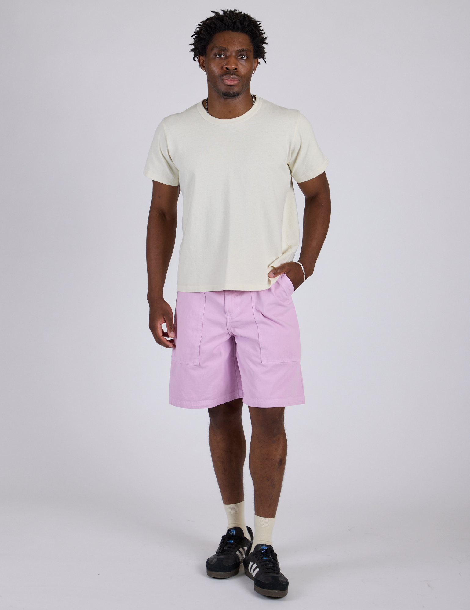 Isaac is 5’10” and wearing M Longline Work Shorts in Lilac Purple paired with vintage tee white Burly Tee