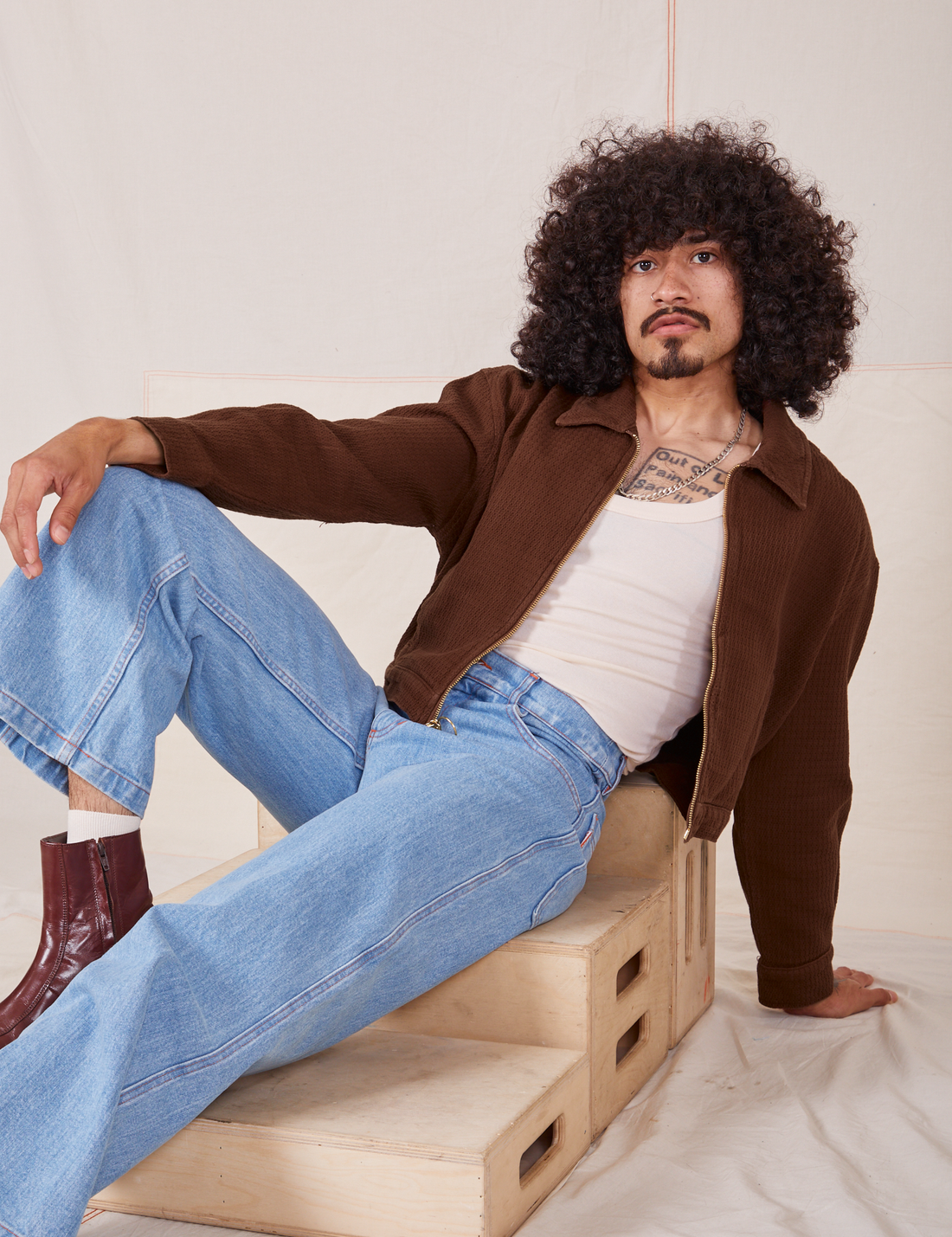 Jesse is 5'8" and wearing XS Ricky Jacket in Fudgesicle Brown paired with a vintage off-white Tank Top and Big Bud Press jeans