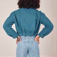 Back view of the Ricky Jacket in Marine Blue and light wash Frontier Jeans worn by Jesse
