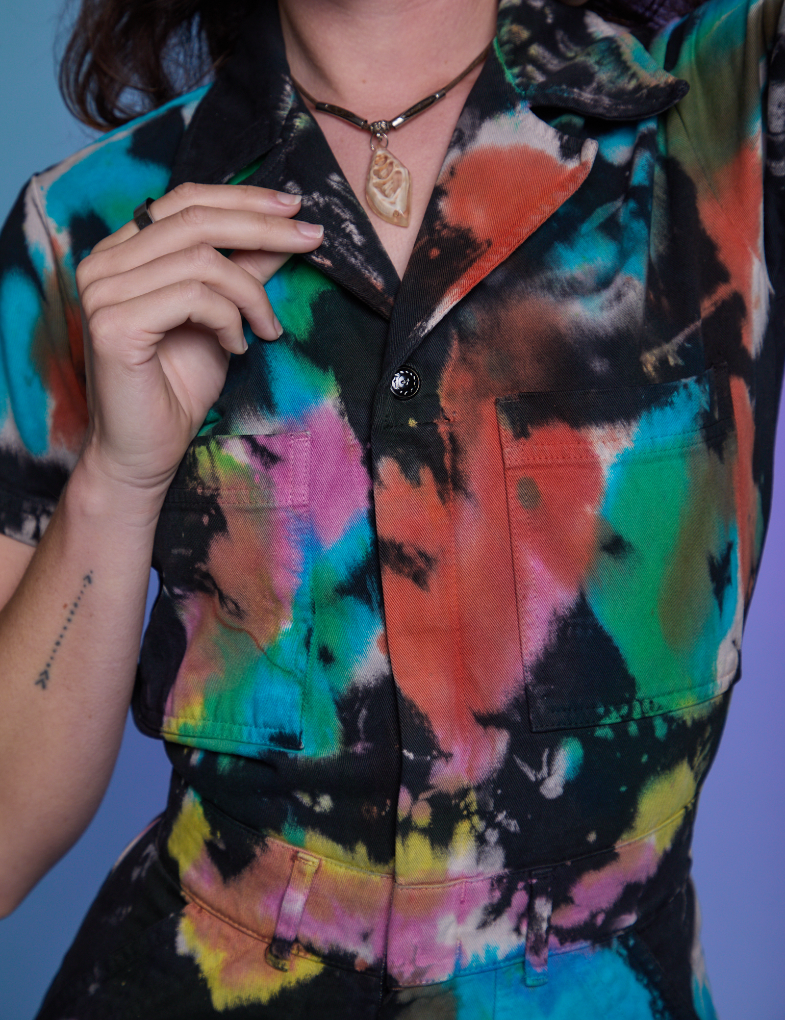 Short Sleeve Jumpsuit in Rainbow Magic Waters front close up on Alex
