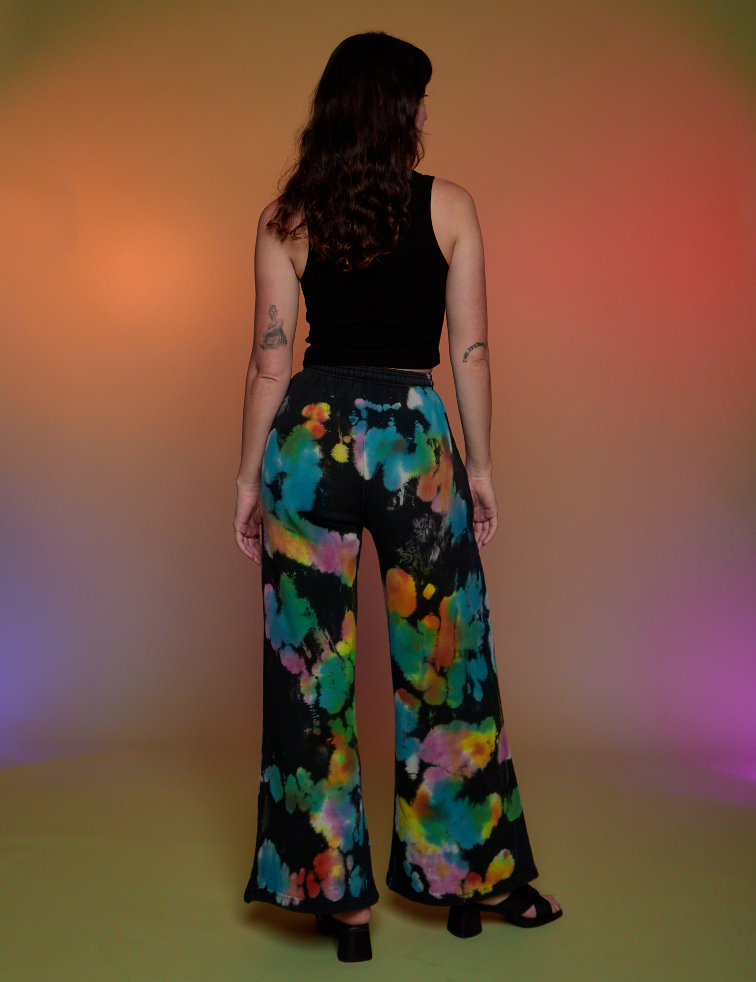 Back view of Tie Dyed Wide Leg Sweat Pants and black Cropped Tank on Alex