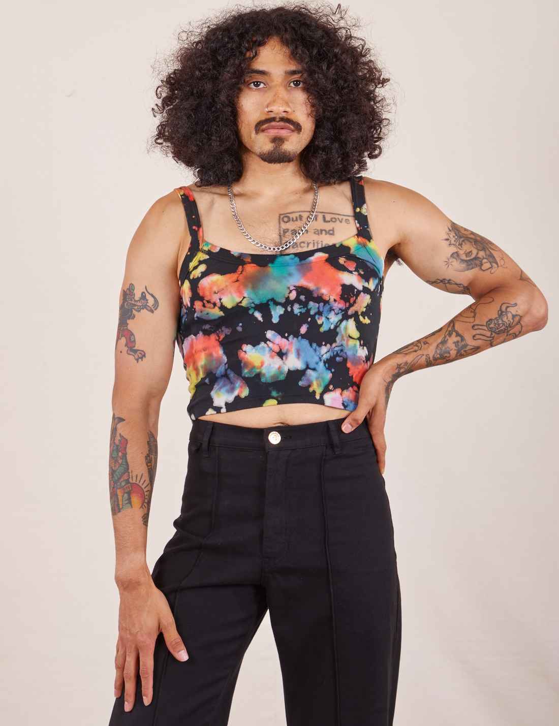 Jesse is 5'8" and wearing XS Cropped Cami in Rainbow Magic Waters paired with black Western Pants