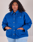 Morgan is wearing a buttoned up Denim Work Jacket in Royal Blue