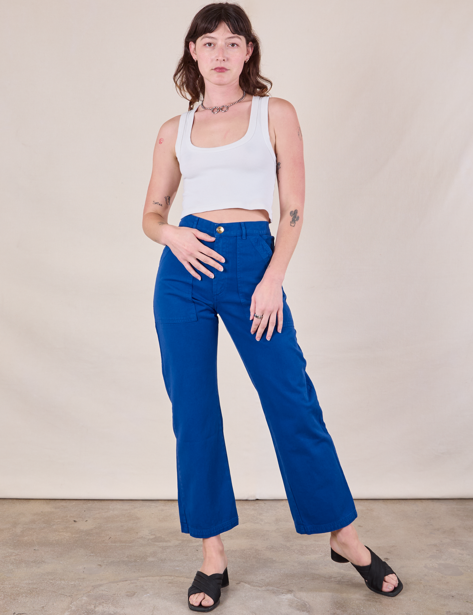 Alex is 5&#39;8&quot; and wearing XS Work Pants in Royal Blue paired with a Cropped Tank in Vintage Tee Off-White