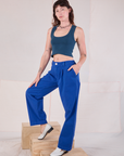 Angled front view of Mid-Rise Pleated Trousers in Royal Blue and lagoon Cropped Tank on Alex