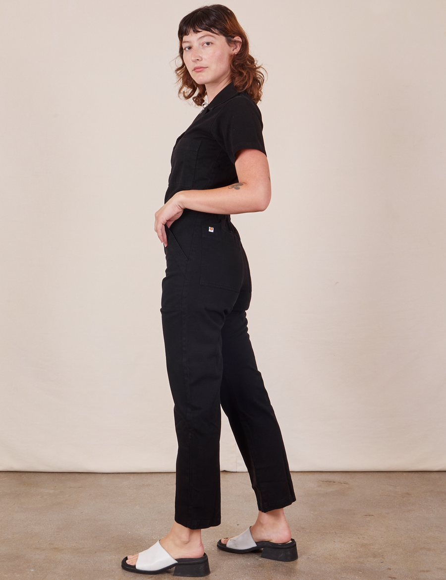 Side view of Short Sleeve Jumpsuit in Basic Black worn by Alex