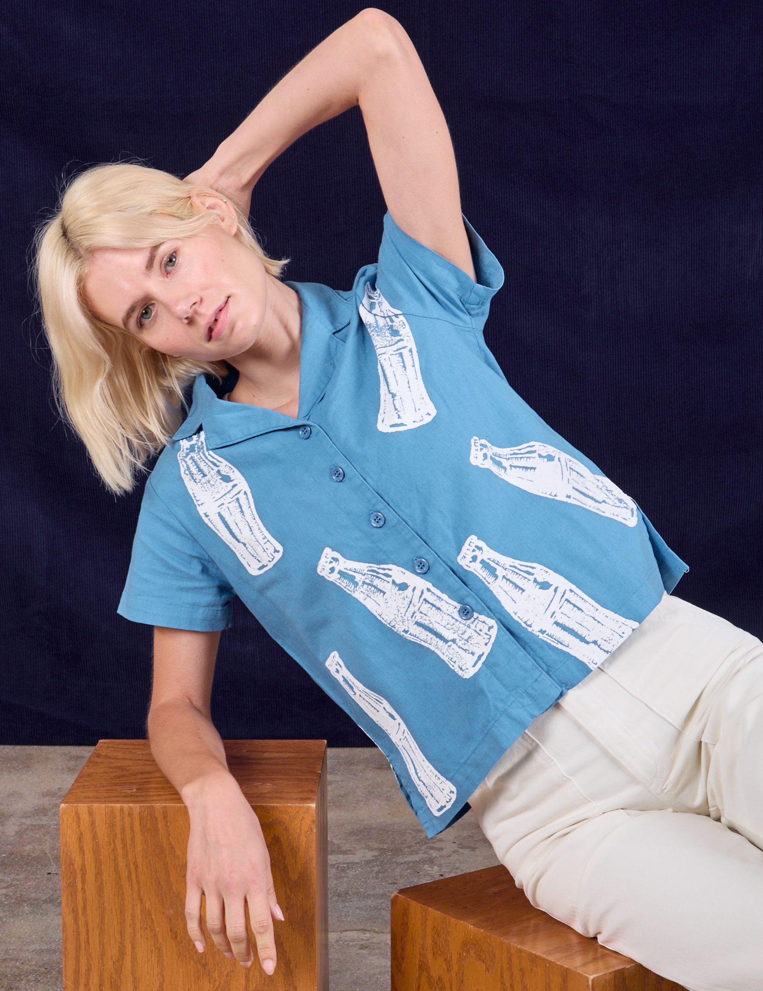 Madeline is wearing Soda Bottle Pantry Button-Up in Greek Blue