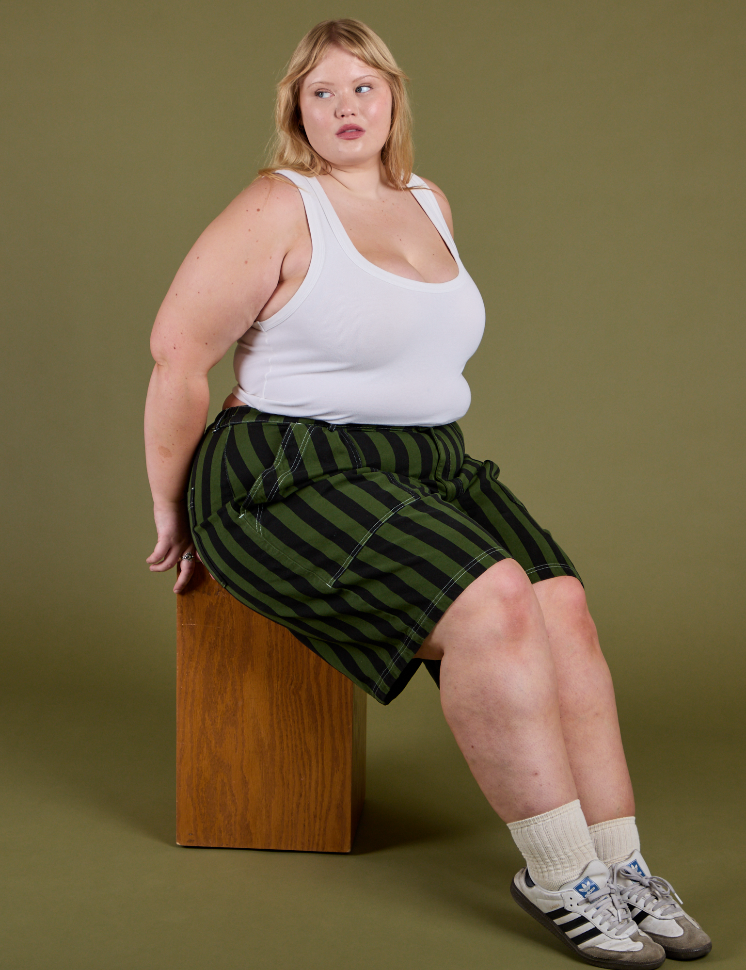 Juliet is wearing  Longline Work Shorts in Evergreen and vintage tee white Cropped Tank