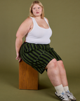Juliet is wearing  Longline Work Shorts in Evergreen and vintage tee white Cropped Tank