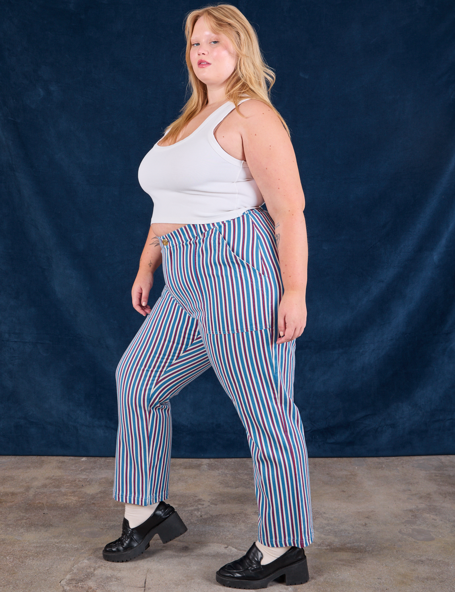 Side view of Stripe Work Pants in Blue Raspberry and Cropped Tank in vintage tee off-white on Juliet