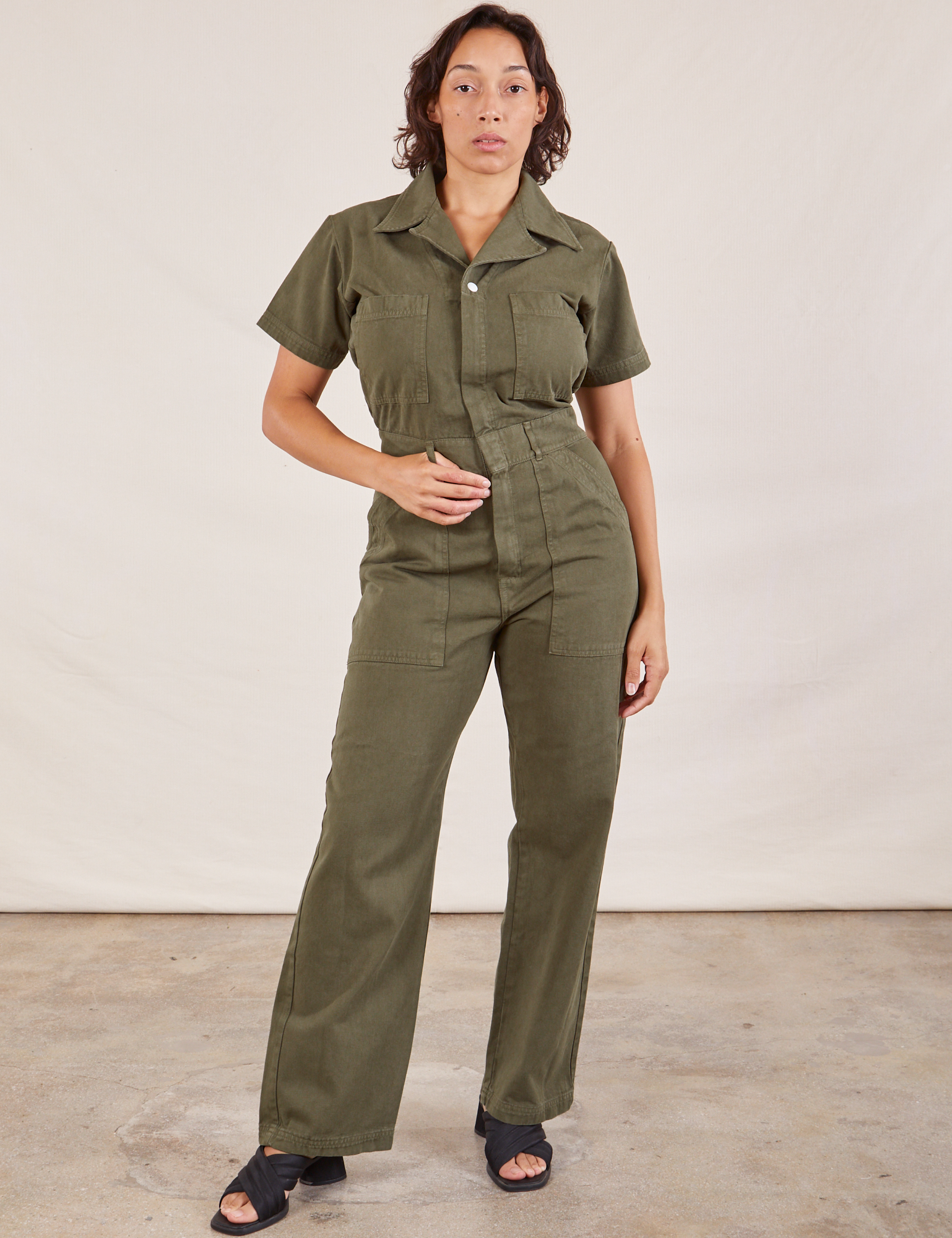 Tiara is 5&#39;4&quot; and wearing S Short Sleeve Jumpsuit in Surplus Green