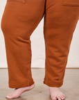 Cropped Rolled Cuff Sweatpants in Burnt Terracotta pant leg close up on Ashley