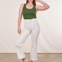 Allison is wearing XXS Tank Top in Dark Emerald Green paired with vintage off-white Western Pants
